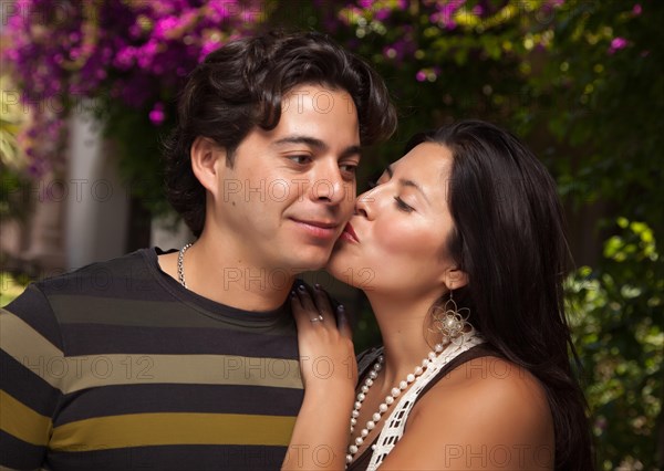 Happy attractive hispanic couple enjoying themselves at the park