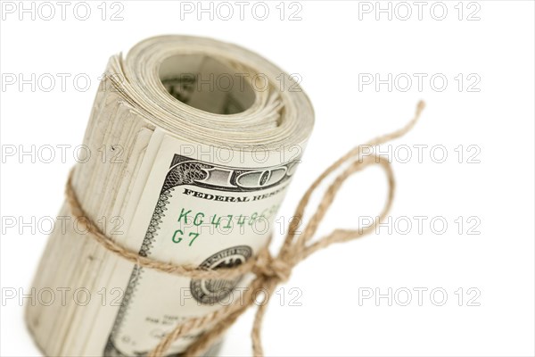 Roll of one hundred dollar bills tied in burlap string isolated on a white background