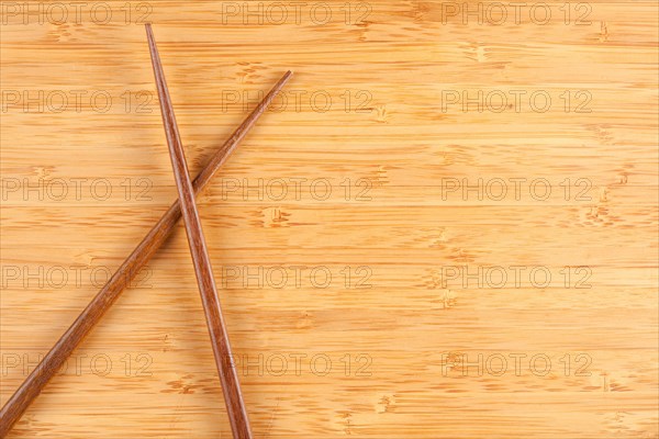 Bamboo textured surface background with chop sticks and plenty of room for text