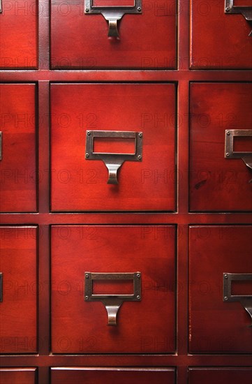 Lustrous wooden card file cabinet in dramatic light