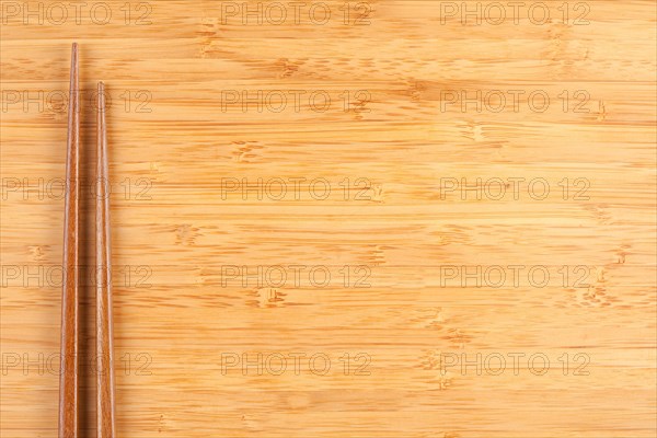 Bamboo textured surface background with chop sticks and plenty of room for text