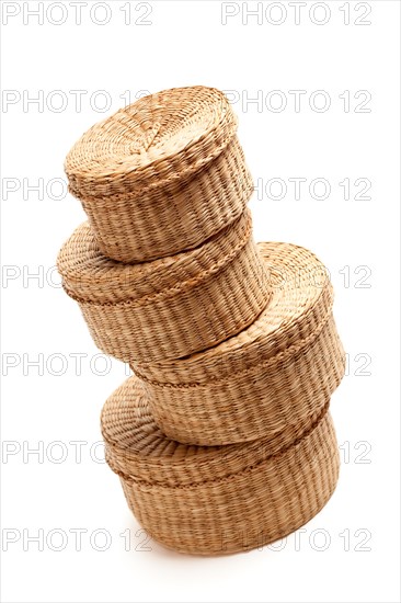 Stack of various sized wicker baskets isolated on white