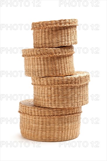 Stack of various sized wicker baskets isolated on white