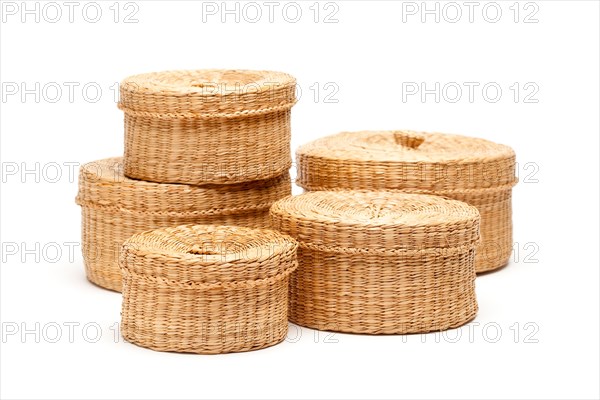 Stack of various sized wicker baskets isolated on white