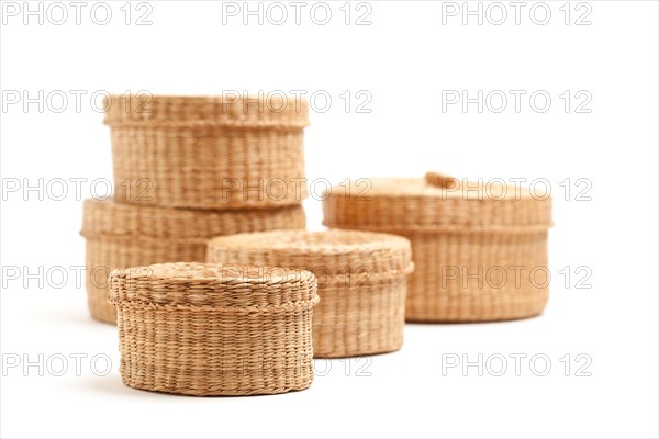 Stack of various sized wicker baskets isolated on white