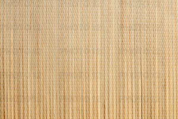 Uniform tan bamboo mat background overhead image