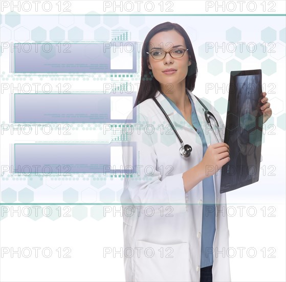 Young doctor or nurse holding x-ray reading over blank futuristic translucent panel