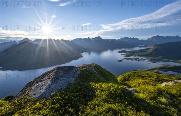 Sun shining on Fjord Raftsund and mountains