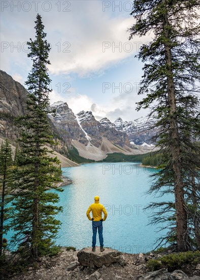 Young man standing on a rock looking into the distance