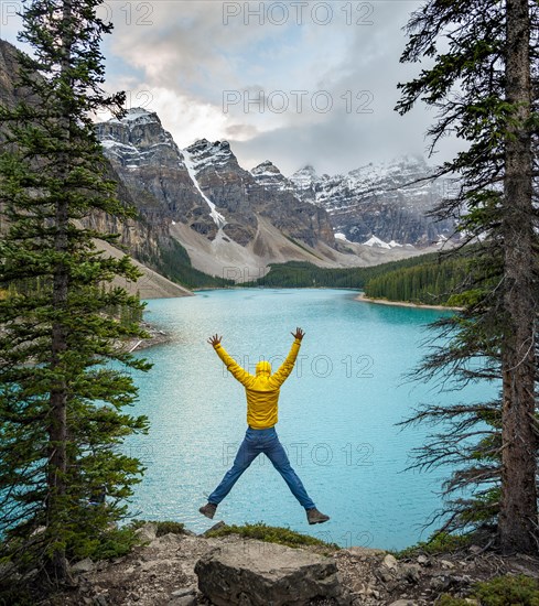 Young man jumps into the air and stretches his arms in the air