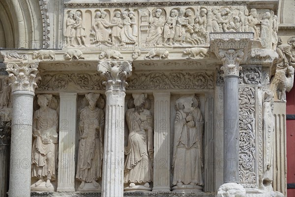 Columns and statues of saints between north portal and main portal
