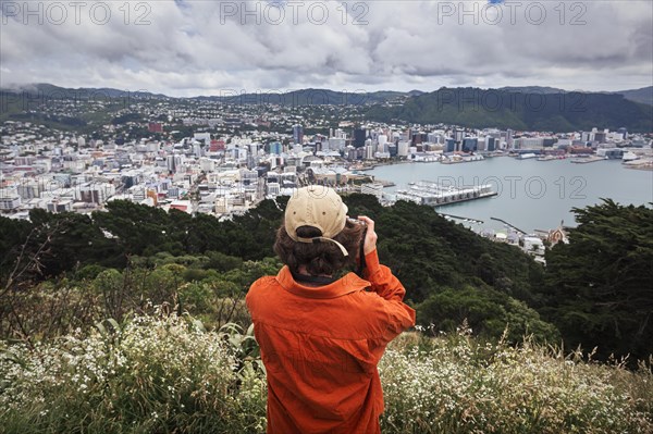 Guy with camera infront of Wellington City