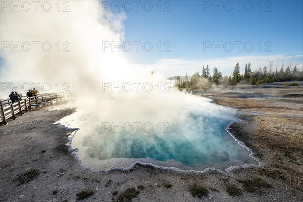 Steaming hot spring with turquoise water in the morning sun