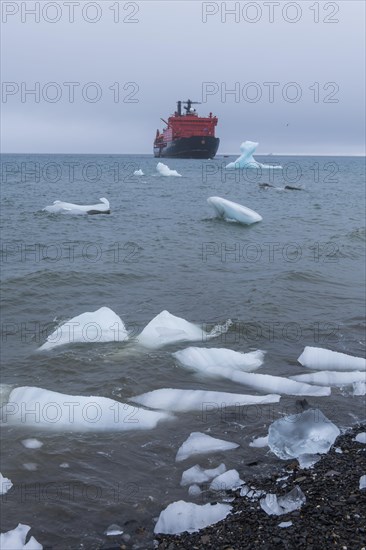 Icebreaker anchoring behind a iceberg