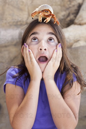 Young pretty girl playing with toy hermit crab