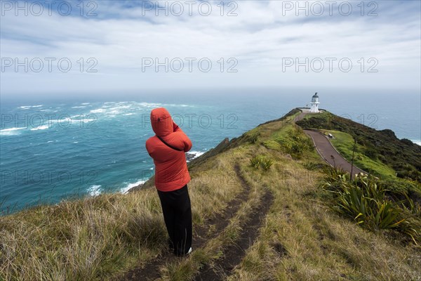 Guy infront of Cape Reinga Lighthouse