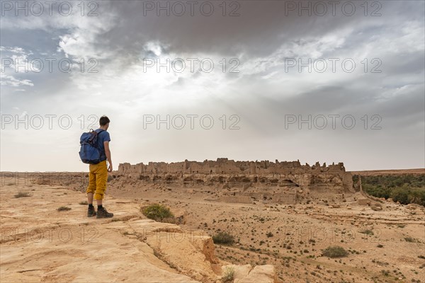 Young man at a cliff edge