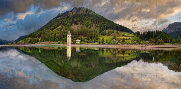 Church tower in the Reschensee with reflection