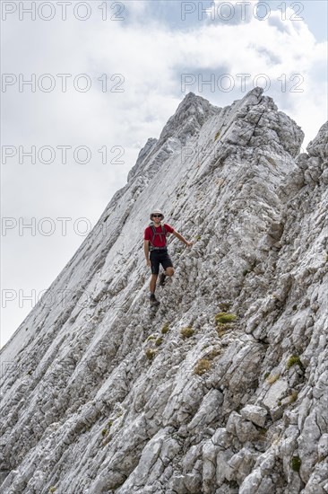 Young man at a rock face