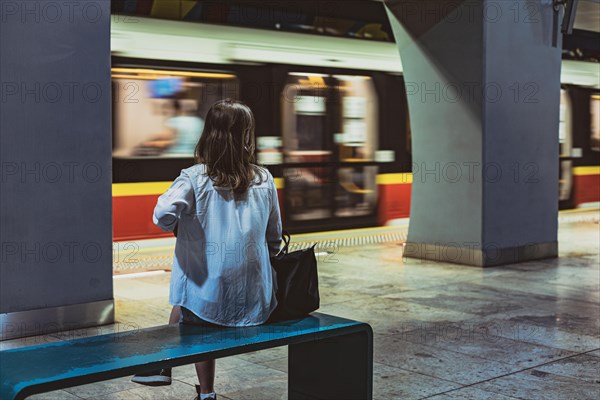 Girl sitting on the bench at metro station