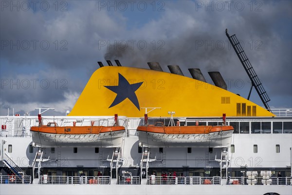 Black smoke rising from the exhaust pipes of a ferry