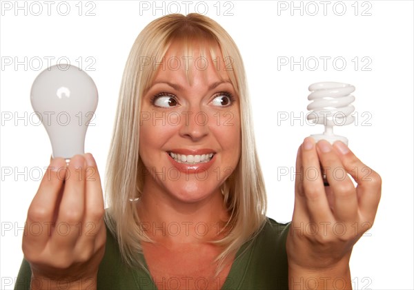 Woman holds energy saving and regular light bulbs isolated on a white background