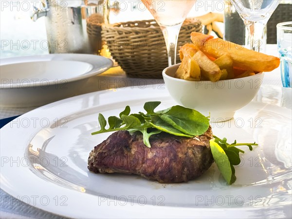 Grilled fillet steak in the evening sun by the sea