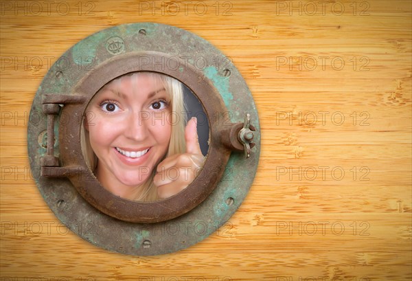 Antique porthole on bamboo wall