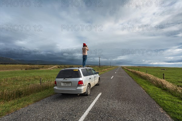 Guy with camera on car roof