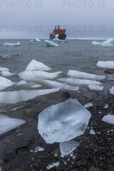 Icebreaker anchoring behind a iceberg