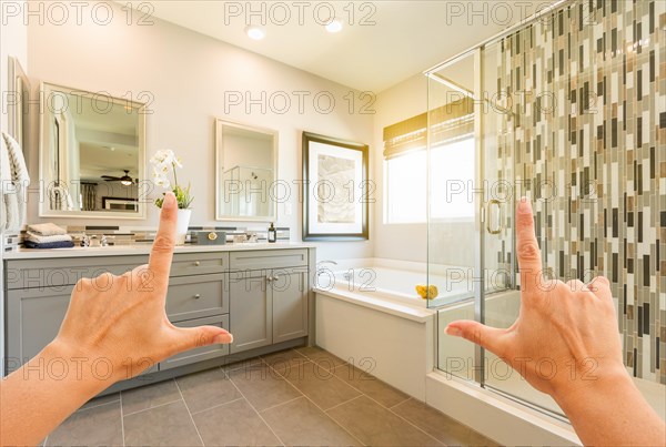 Hands framing custom master bathroom interior