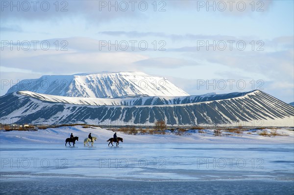 Riders in front of on partly frozen lake Myvatn