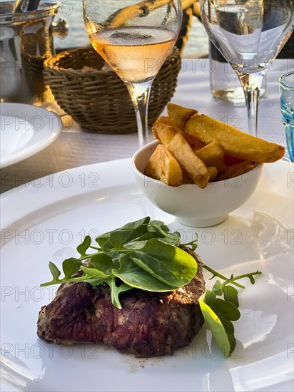 Grilled fillet steak in the evening sun by the sea