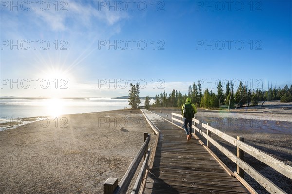 Hiker on boardwalk at West Thumb of Yellowstone Lake