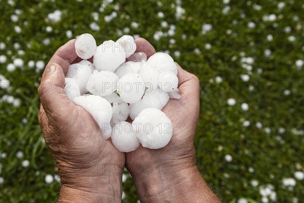 Golfball-sized hailstones in hands