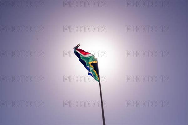 South African flag seen against sun background