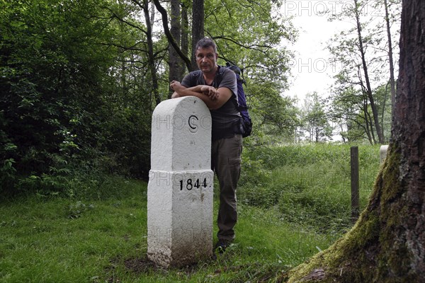 Hiker at the border stone