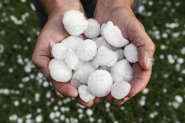 Golfball-sized hailstones in hands