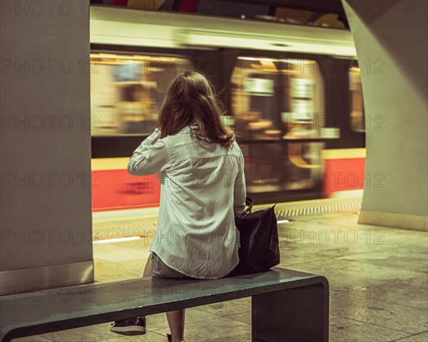 Girl sitting on the bench at metro station