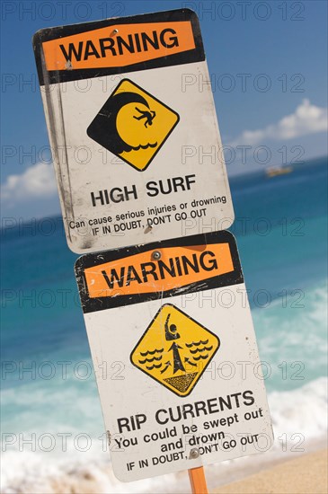 Surf and currents warning sign on a beach in hawaii