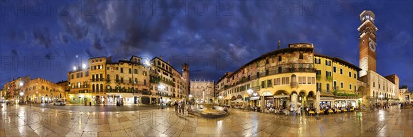 360 panorama of the city square Piazza delle Erbe and former Roman Forum with fountain Fontana Madonna Verona and the medieval tower Torre dei Lamberti in the evening