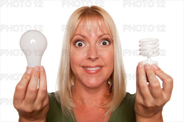 Woman holds energy saving and regular light bulbs isolated on a white background