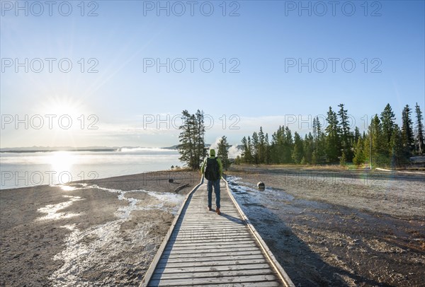 Hiker on boardwalk at West Thumb of Yellowstone Lake