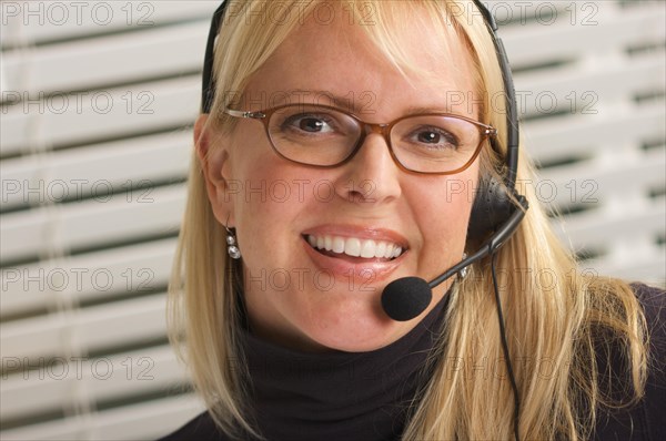 Attractive businesswoman talks on her phone headset
