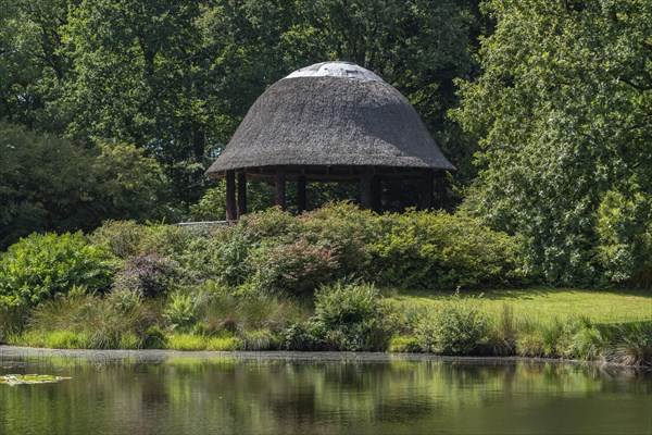 Lake with pavilion in landscape garden and castle park