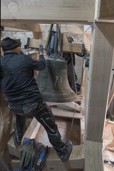 Bell is pulled into the new belfry by means of a chain winch