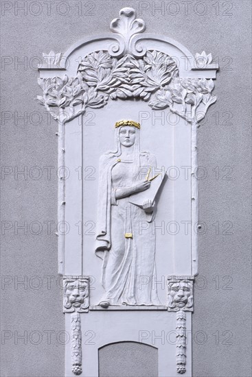 Art Nouveau relief of a woman with compasses on a residential house from 1908