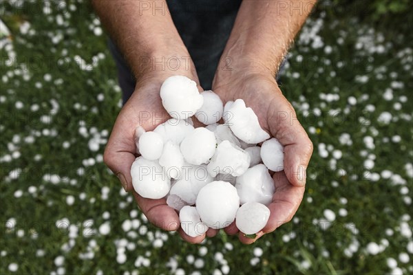 Golfball-sized hailstones in hands