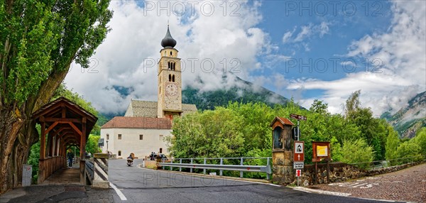 Parish church St. Pankraz with old Etsch wooden bridge