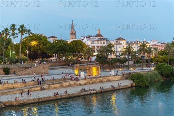 Waterfront Muelle de la sal at the river Rio Guadalquivir with Monumento a la Tolerancia